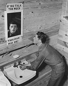 Sign on mirror reads: IF YOU TALK TOO MUCH THIS MAN MAY DIE